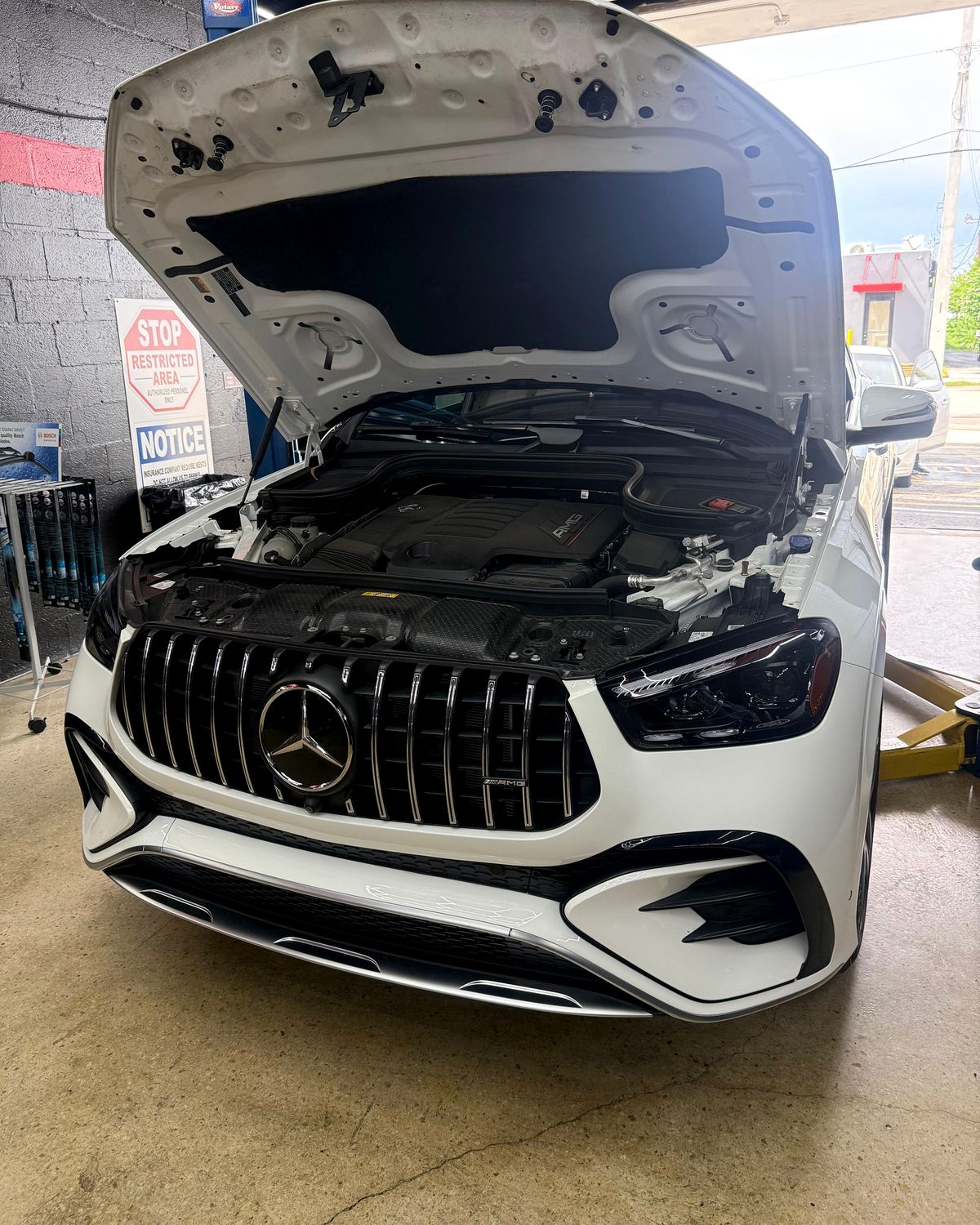 White Mercedes-AMG GLC with the hood open in the bay